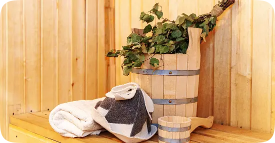 Traditional sauna setup with oak whisks and towels